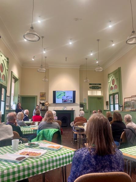 Image of Bat & Ball Station forget-me-not cafe event. People sat facing the spekaers Kent Wildlife Trust